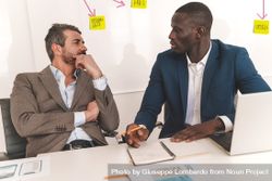 Two businessmen strategizing a project in an office 0LdLDX