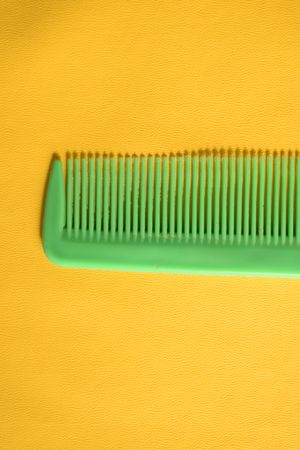 Bright green hair comb in yellow scene