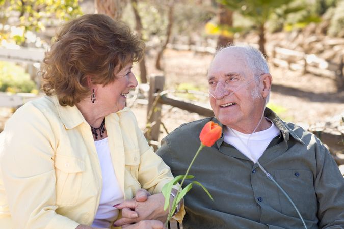 Mature Woman with Man Wearing Oxygen Tubes