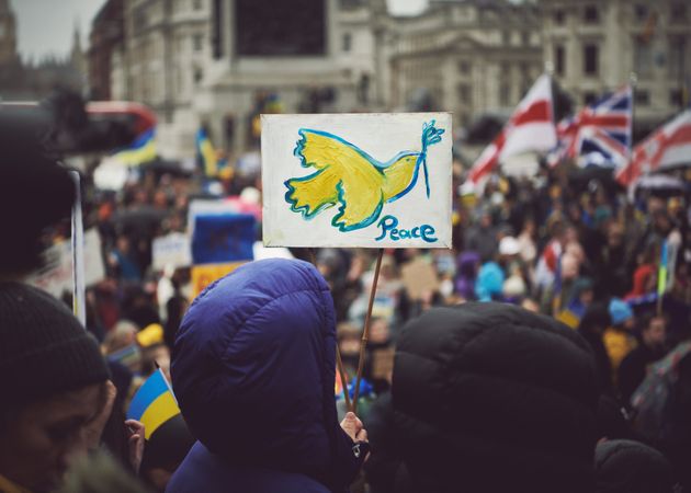 London, England, United Kingdom - March 5 2022: People holding a “peace” sign with bird