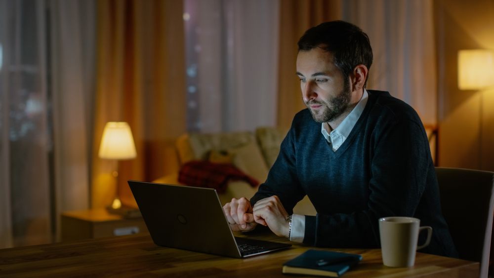 Man Works on a Laptop from His House.