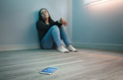 Unrecognizable woman with phone addiction looking at her mobile