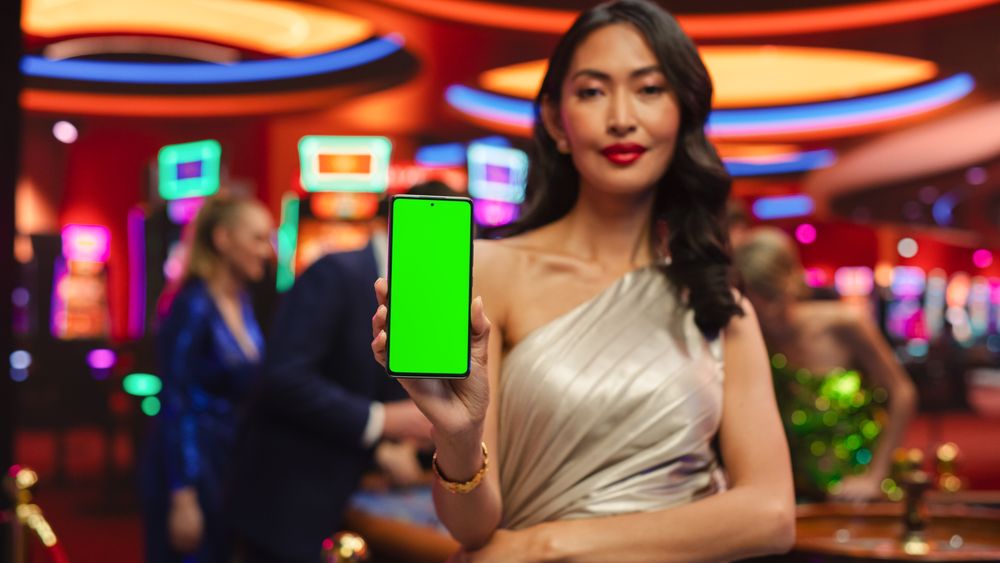 Advertising Template with an Asian Female Showing a Smartphone Device with a Green Screen Mock Up Display with Trackers.
