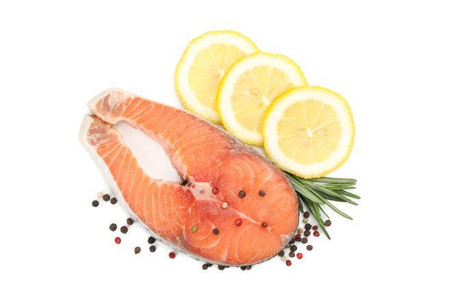 Fresh raw salmon meat and spices isolated on light background