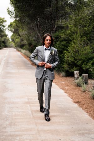 Groom walking on road at nature