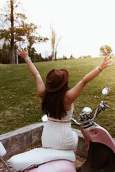 Woman spreading arms wide open to sun