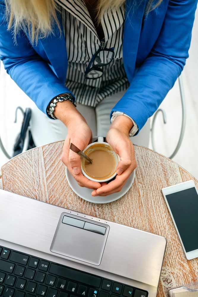 Hands of businesswoman holding a cup of coffee