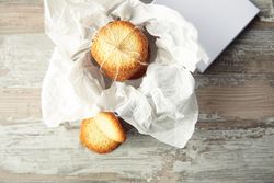 Open box of wrapped sugar cookies on kitchen counter