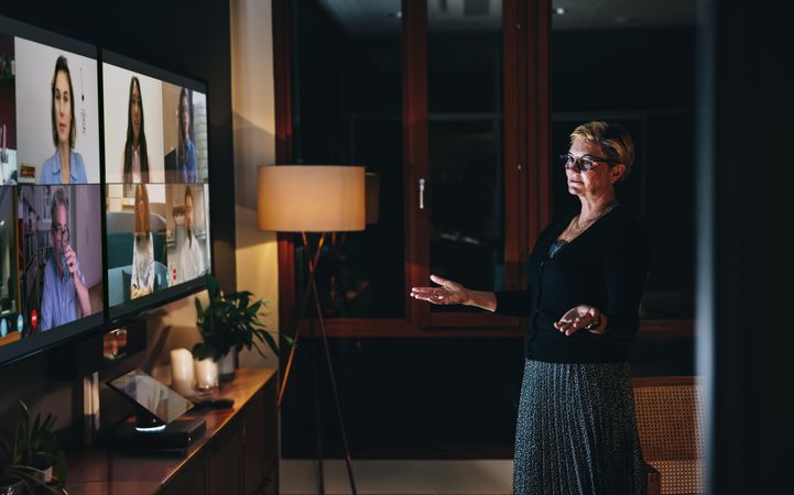 Businesswoman leading a video conference call from her tv screen