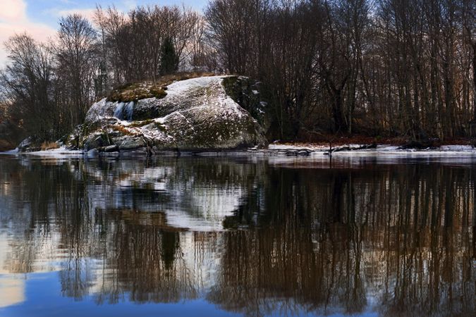 Frosted bank of river with bare trees
