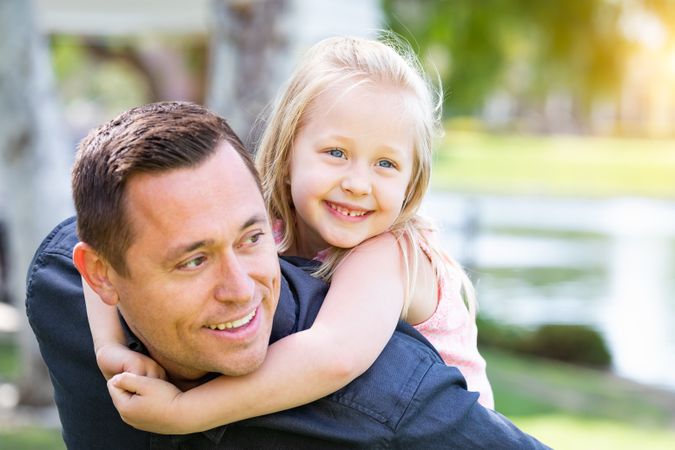 Young White Father and Daughter Having Fun At The Park