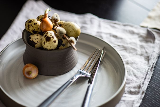 Decorative cup of speckled mini eggs on table setting