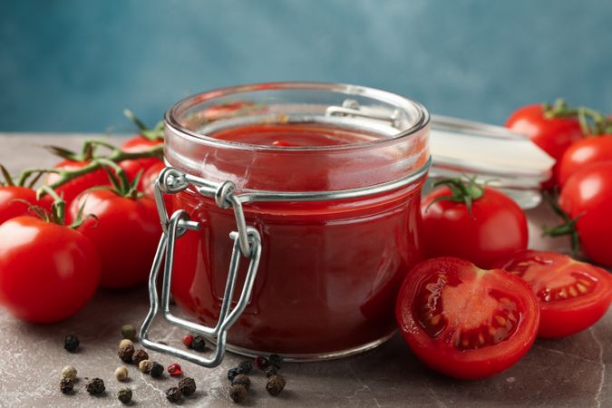 Fresh red tomatoes and sauce, close up. Ripe vegetable