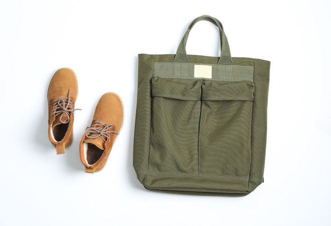 Winter boots with backpack on blank background, top view