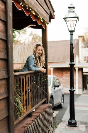 Woman standing at the balcony of her home