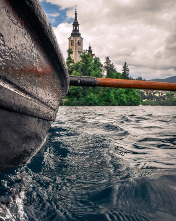 Selective focus photo of boat and paddle in water