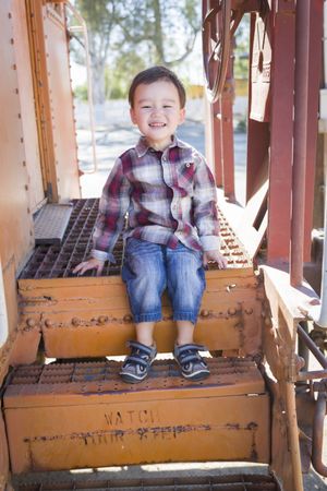 Cute Biracial Boy Having Fun on Railroad Car