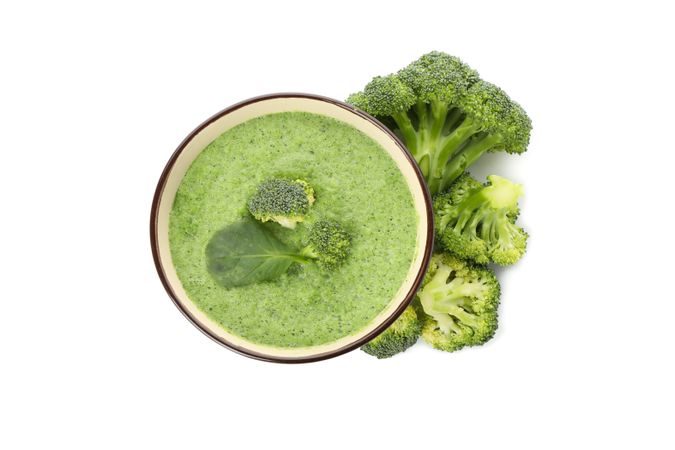 Looking down at top of broccoli soup with ingredients