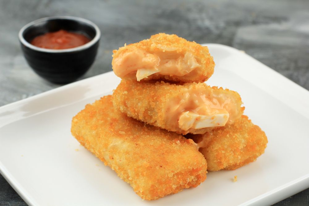 Pile of risol mayo keju, fried thin crepes rolled with egg and mayonnaise filling
