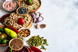 Bowls of legumes and aromatics on kitchen counter