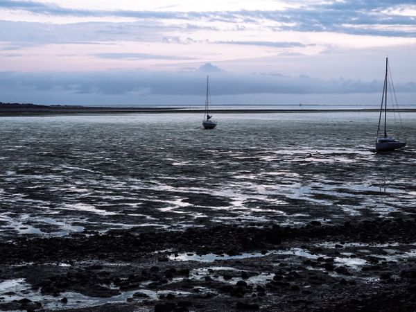 Grounded sail boats at low tide