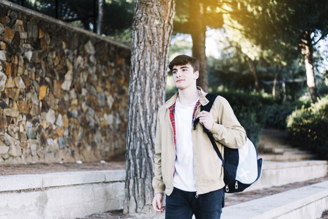 Man strolling outside with backpack