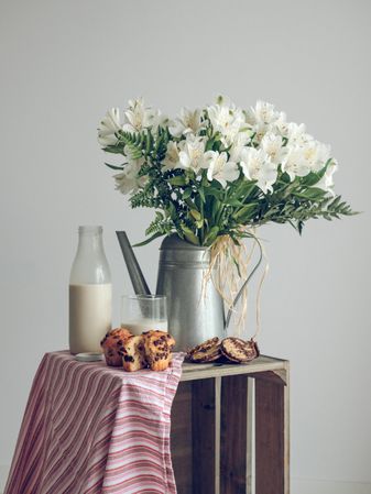 Bouquet of flowers and food on wooden crate