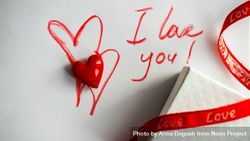 Valentine Day holiday concept with "I love you" written on paper with giftbox and heart ornament 41llpp