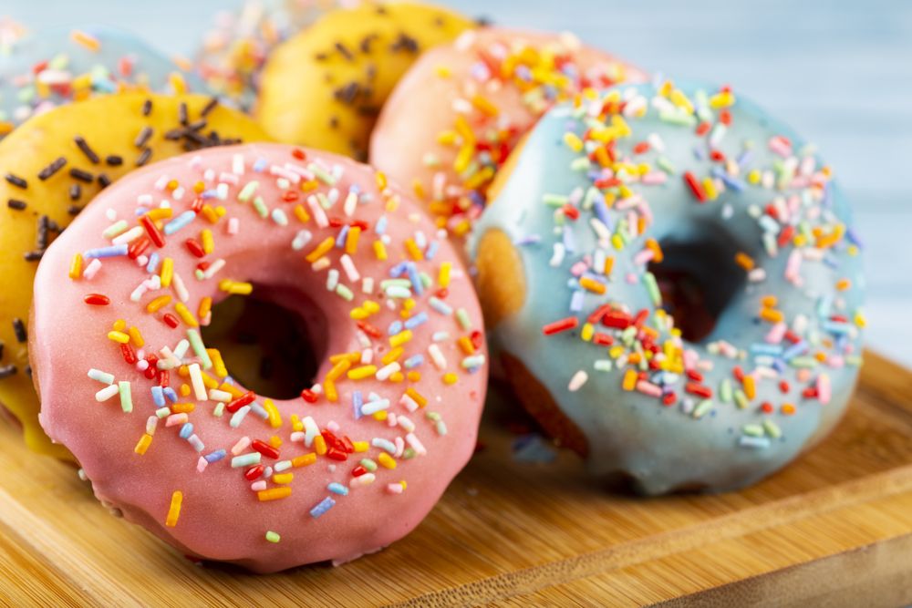 Delicious assorted colorful donuts on the table.