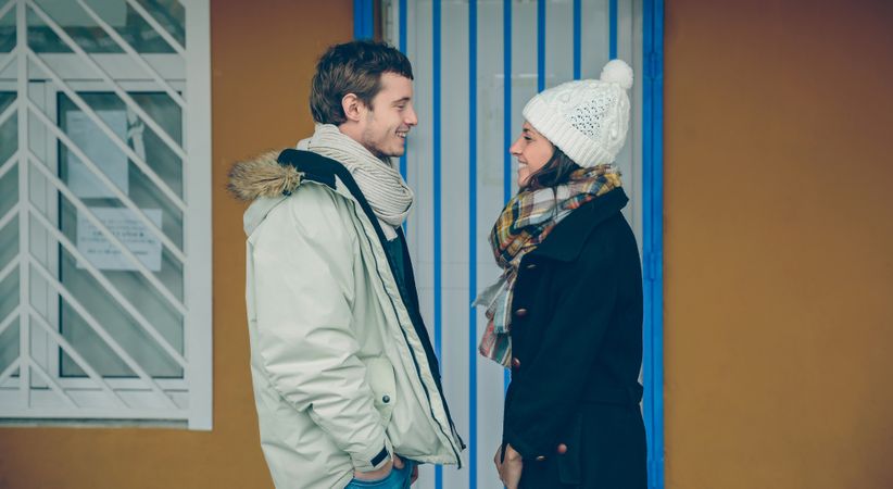 Portrait of happy couple looking each other and laughing outdoors