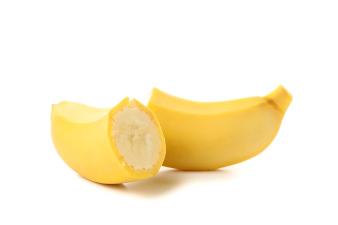 Banana halves isolated on neutral background. Fresh fruit