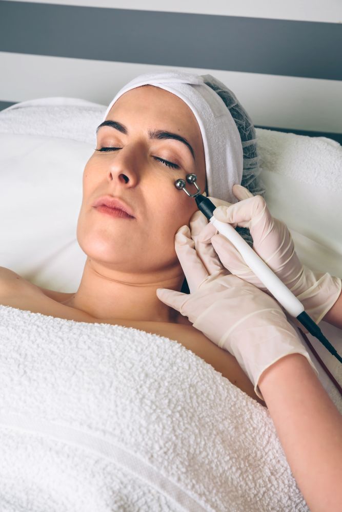 Woman receiving facial treatment on eyes in beauty center