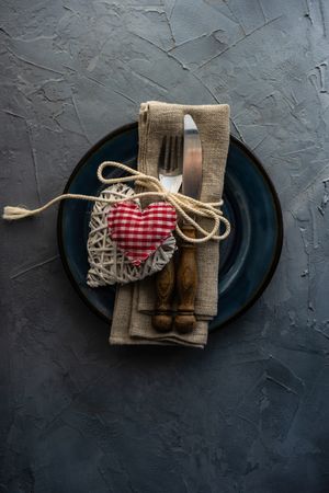 Valentine's day concept with silverware on plate with with napkin and thatched heart