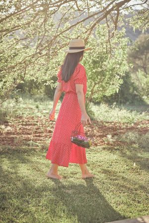 Woman walking in summer garden