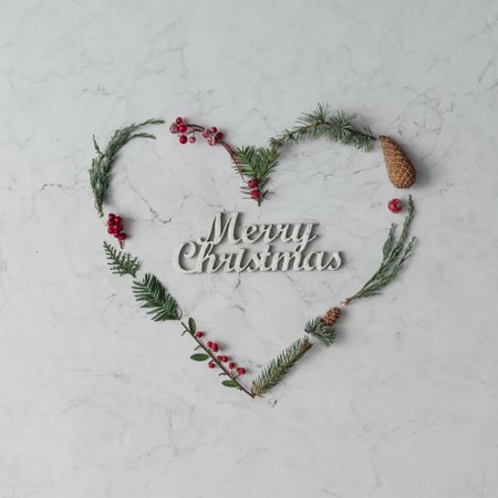 Heart shape made of winter foliage with the words “Merry Christmas”
