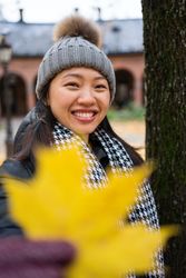 Cheerful young Asian female traveler enjoying sightseeing in Oslo