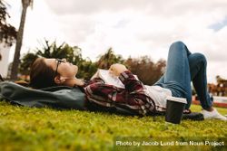 Young woman relaxing at a park on college campus 0KnmMb