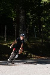 Professional cyclist riding bike in park