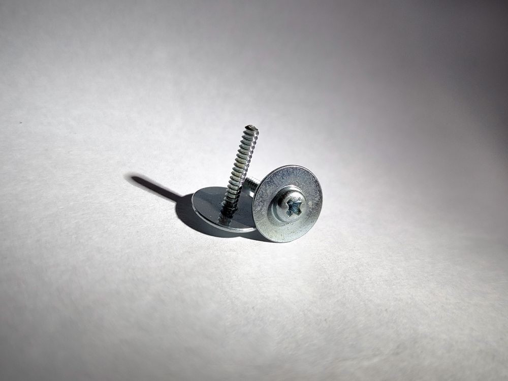 Screws on plain background