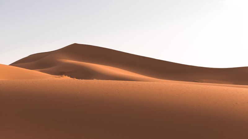 Desert dunes under sky