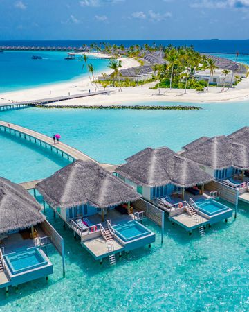 Drone shot of a row of back patios of holiday villas on tropical beach resort