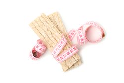 Measuring tape with fitness bread isolated on light background