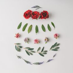 Easter egg shape made of colorful spring flowers and green leaves