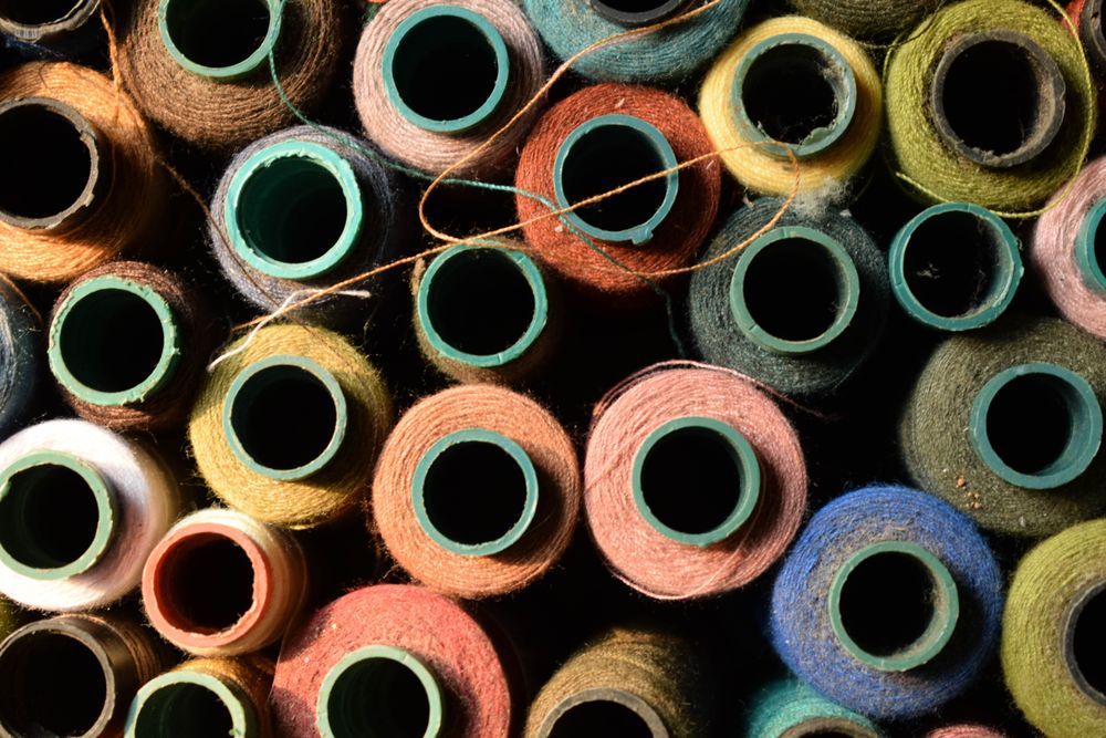 Pile of colorful spools for sewing machine