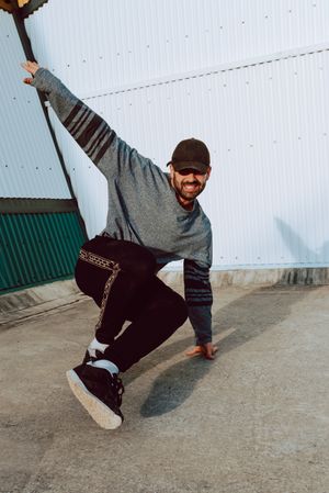 Man performing handstand near wall