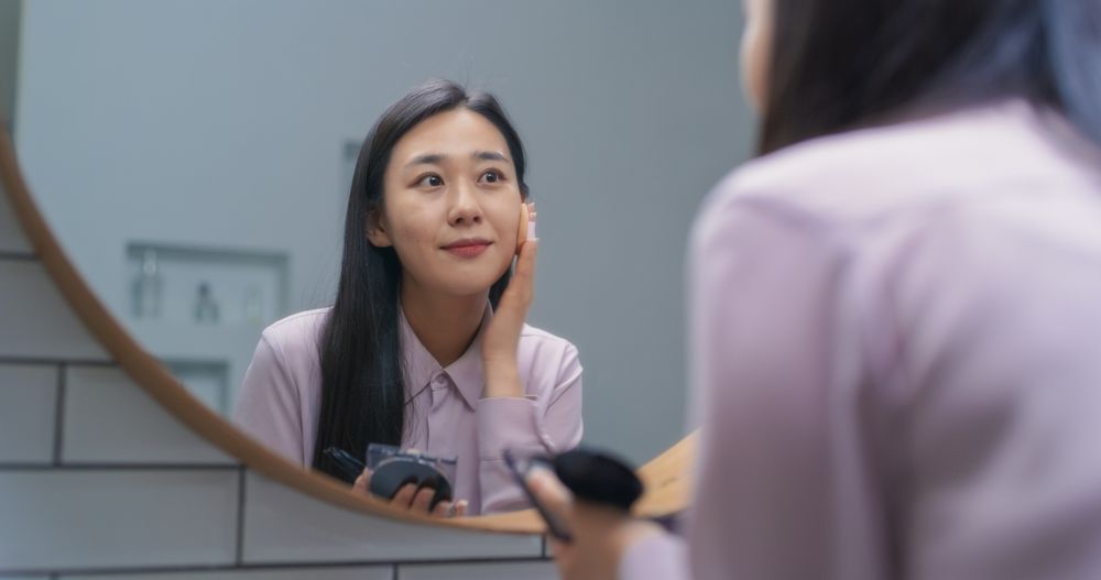 South Korean Female Putting on Makeup in a Bathroom at Home.