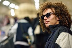 Man looking around with sunglasses in an underground station in London