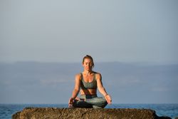 Woman meditating in Lotus pose