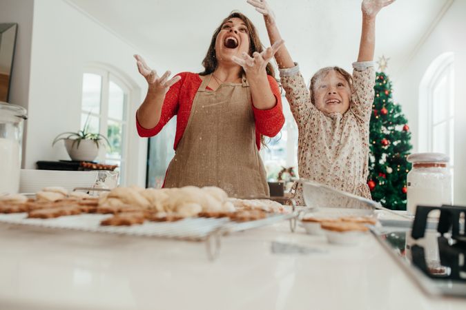 Mother and daughter having fun while baking for the holidays