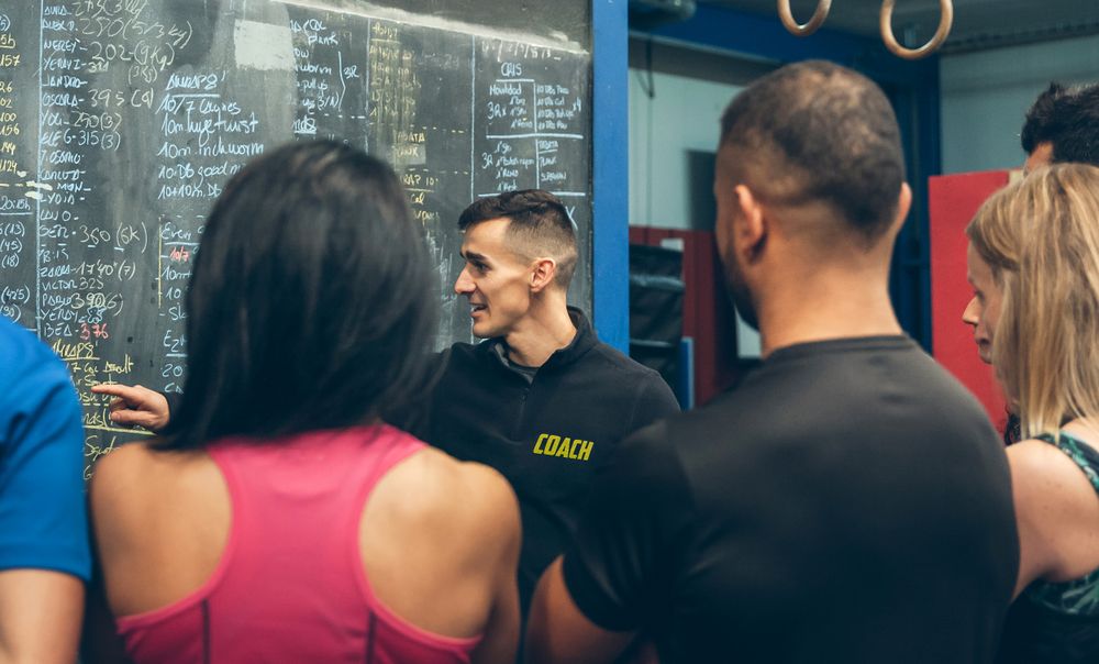 Coach explaining to athletes in the gym